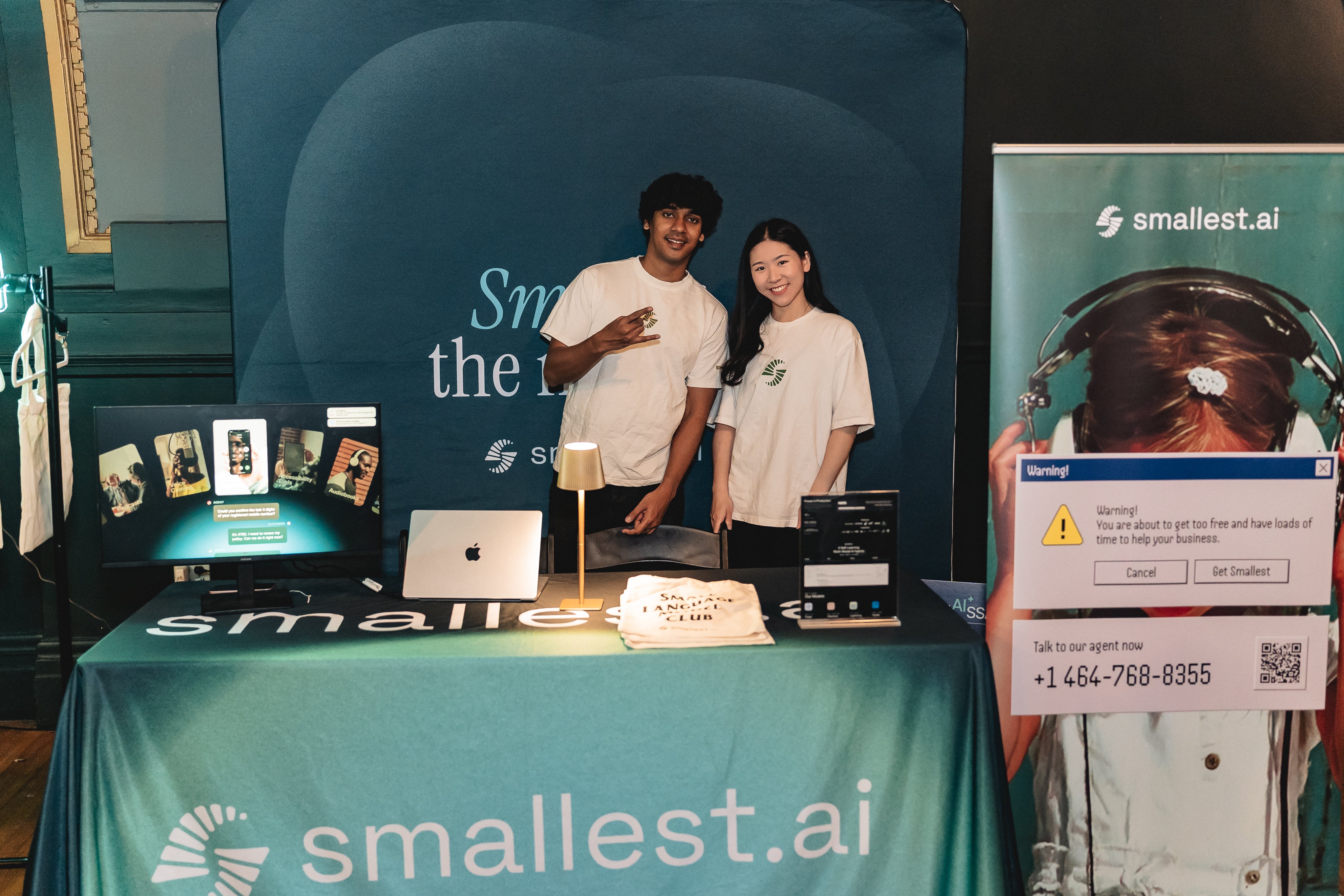 Smallest AI booth with team members and creative Windows warning dialog display